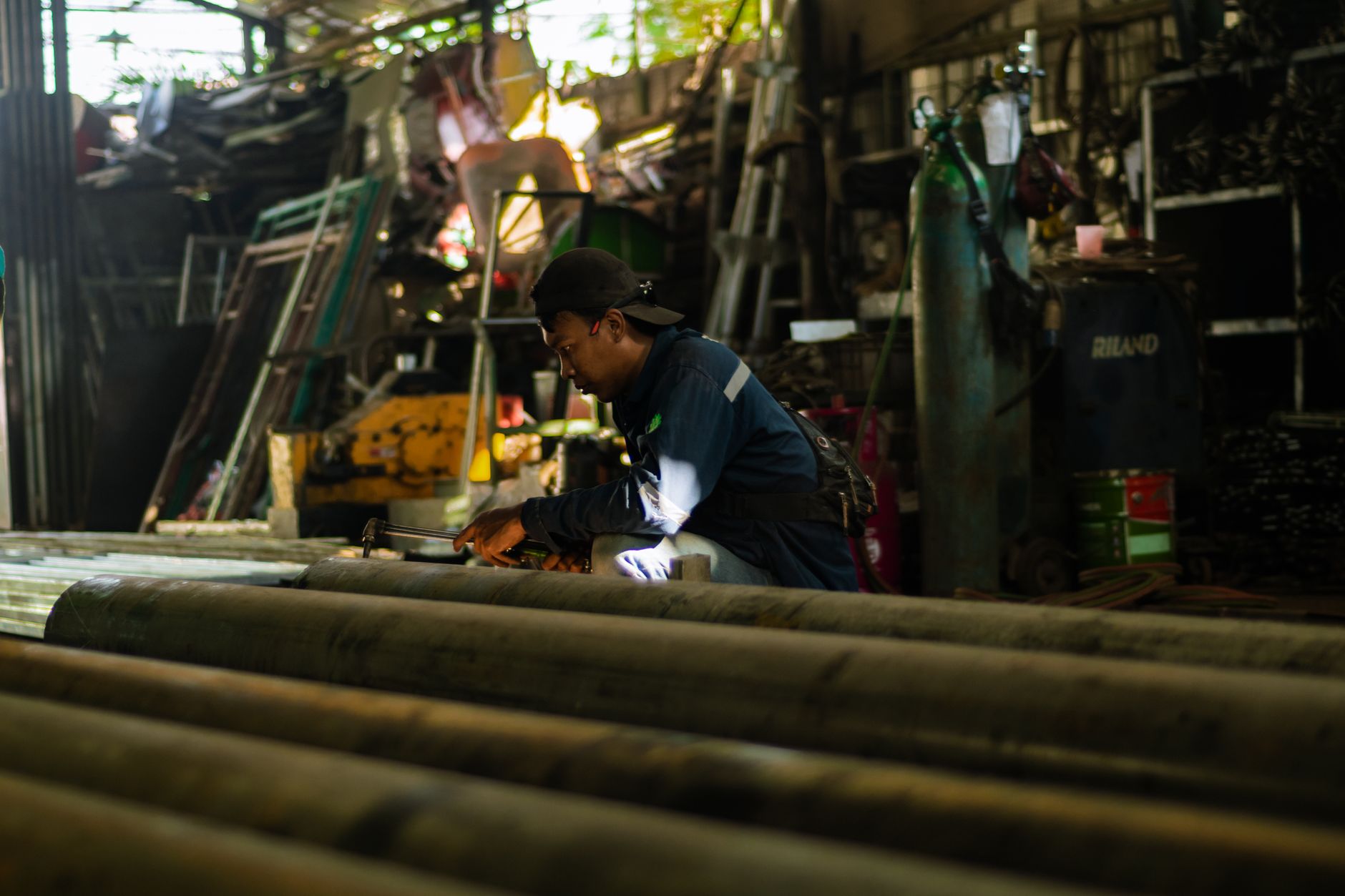 Technician checking suction line fittings on a pump system