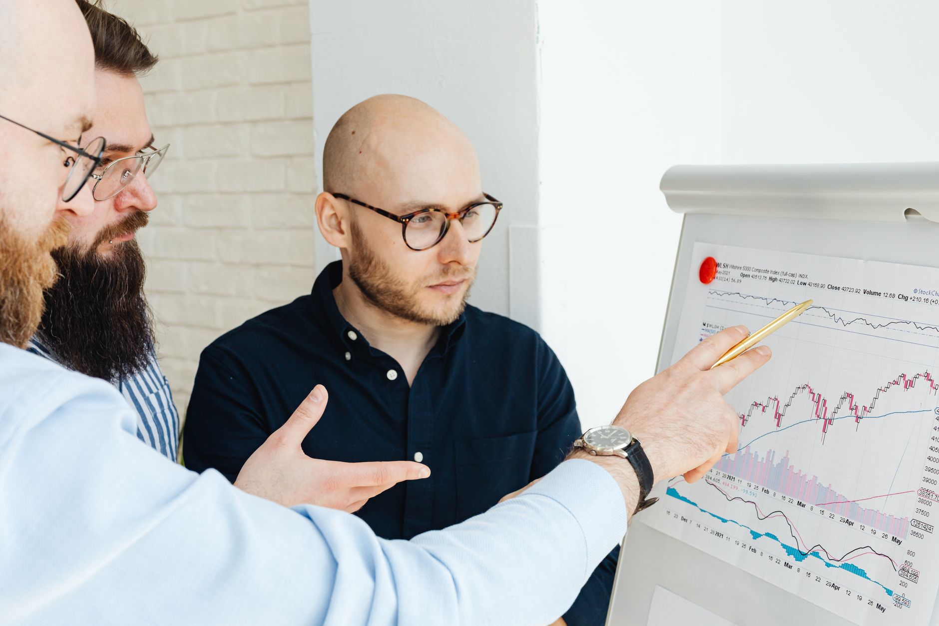 Team reviewing a House of Quality matrix diagram