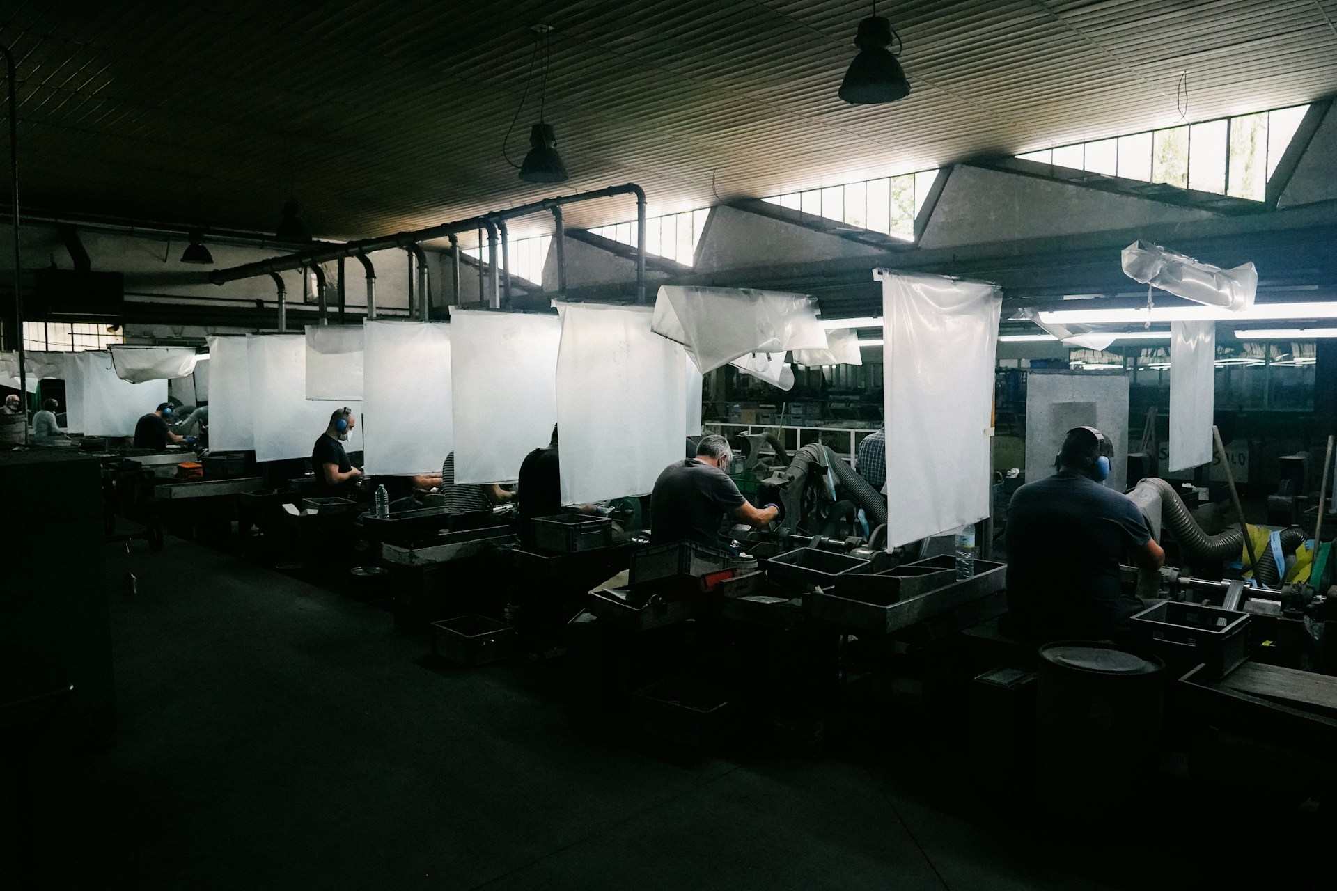Workers at individual stations on a production floor