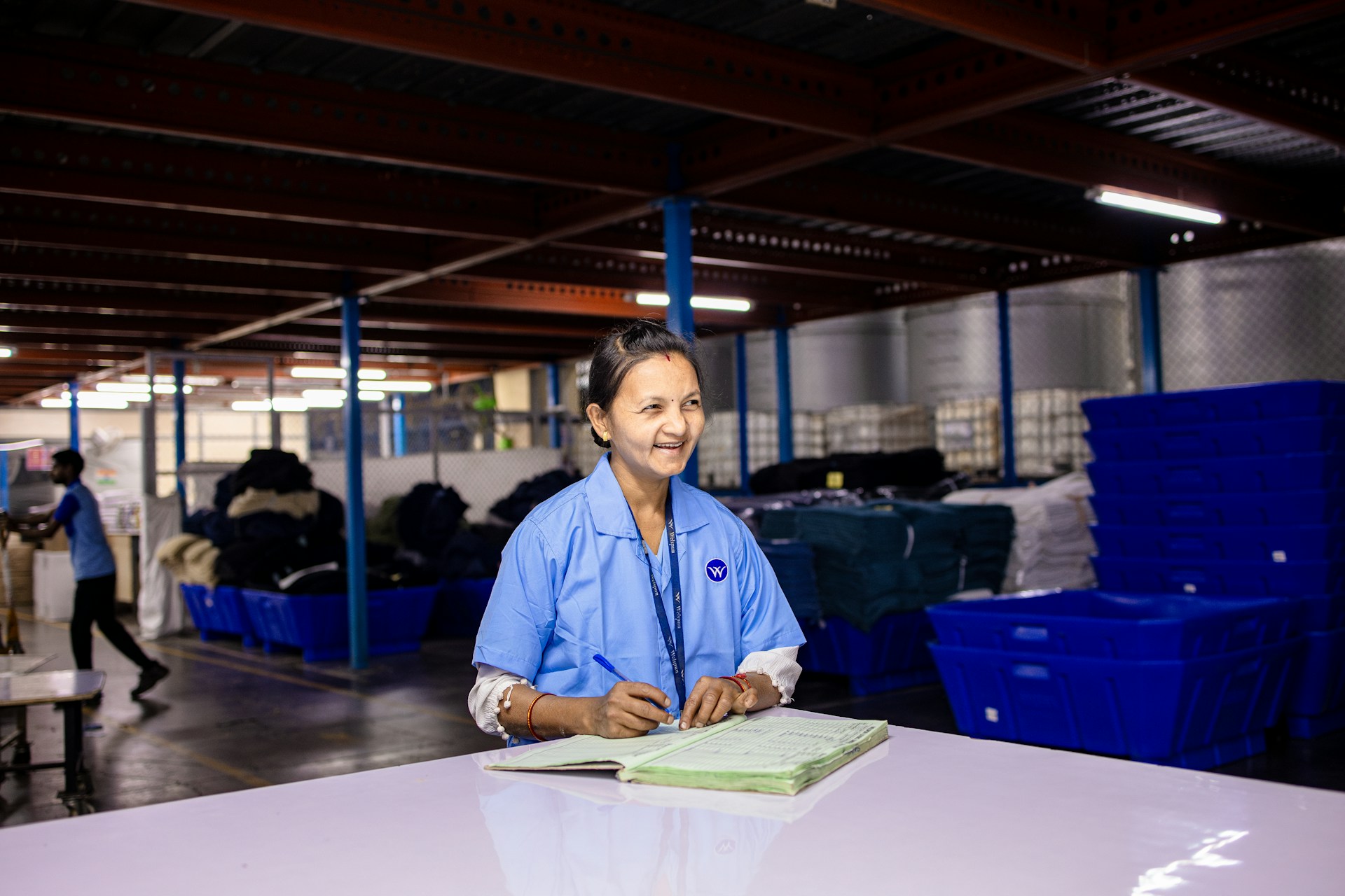Worker documenting findings in a facility log book