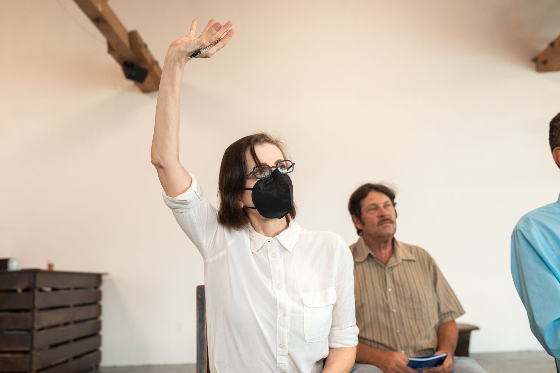 Instructor demonstrating proper respirator mask fit to trainees