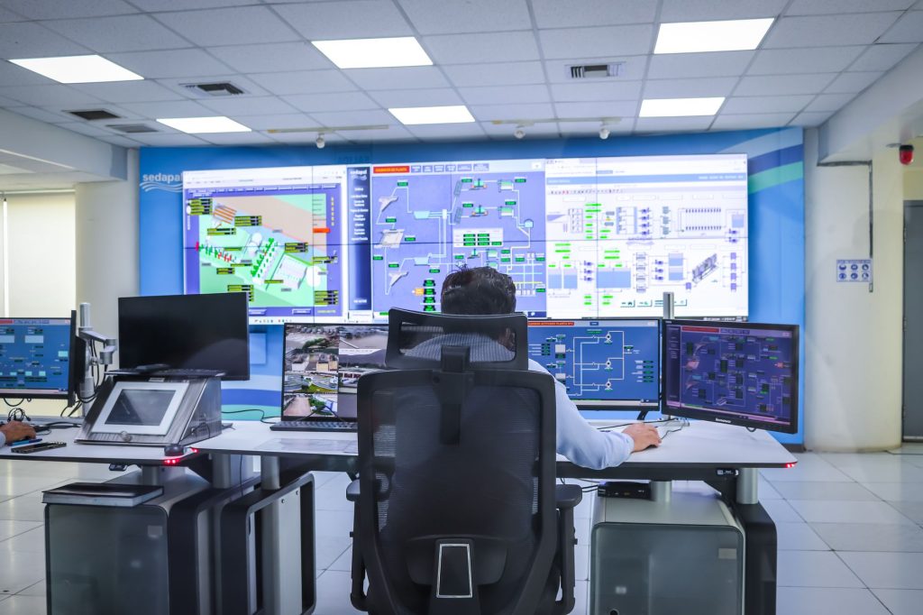 Industrial control room with SCADA monitoring screens