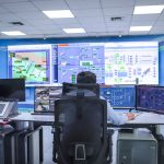 Industrial control room with SCADA monitoring screens