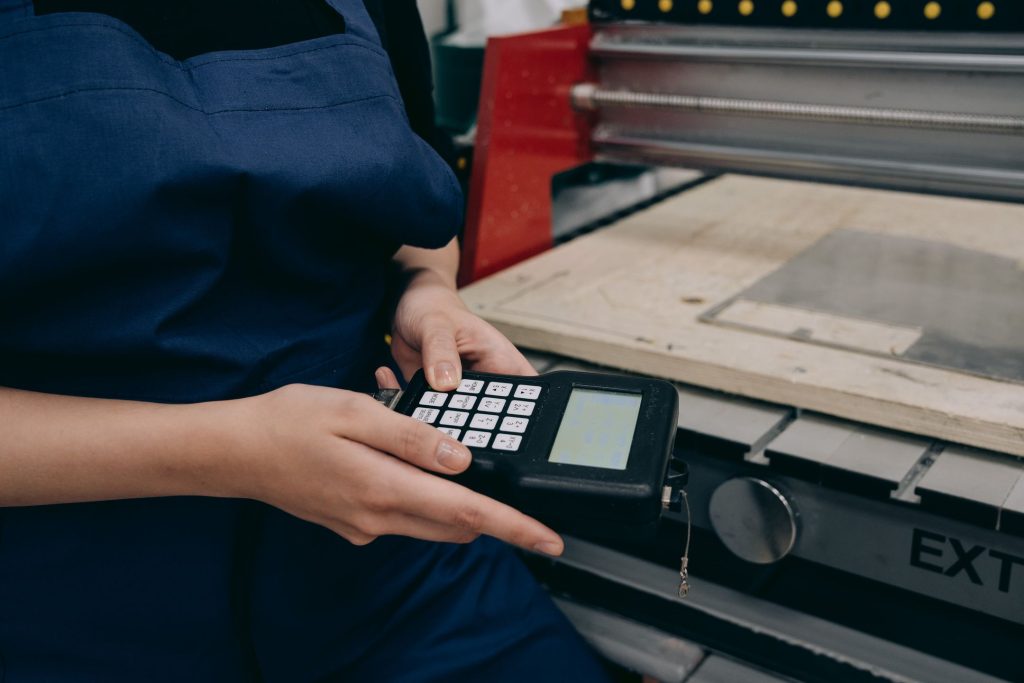 Technician using a digital controller in an industrial setting