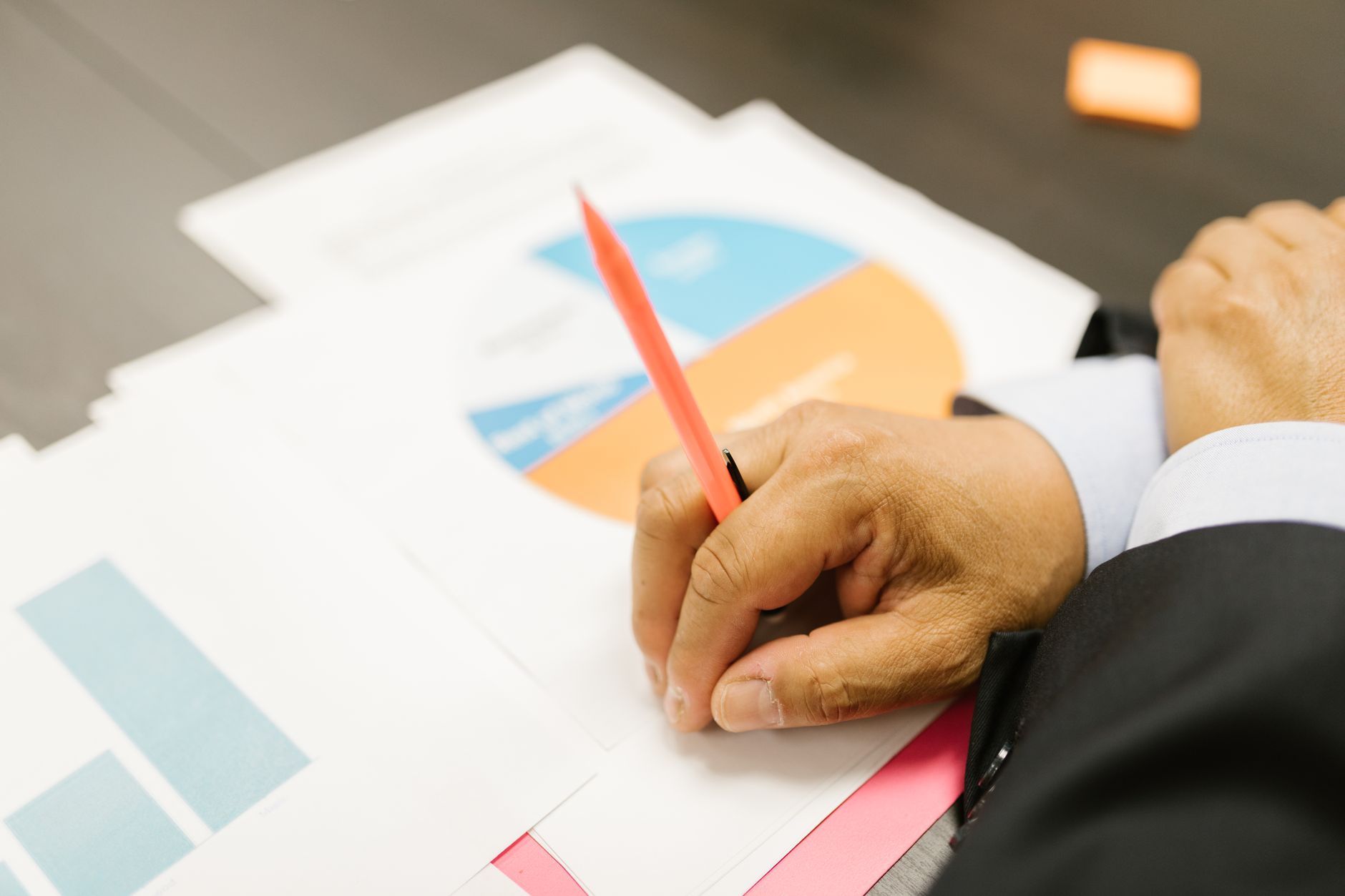 Quality technician plotting data points on a paper control chart