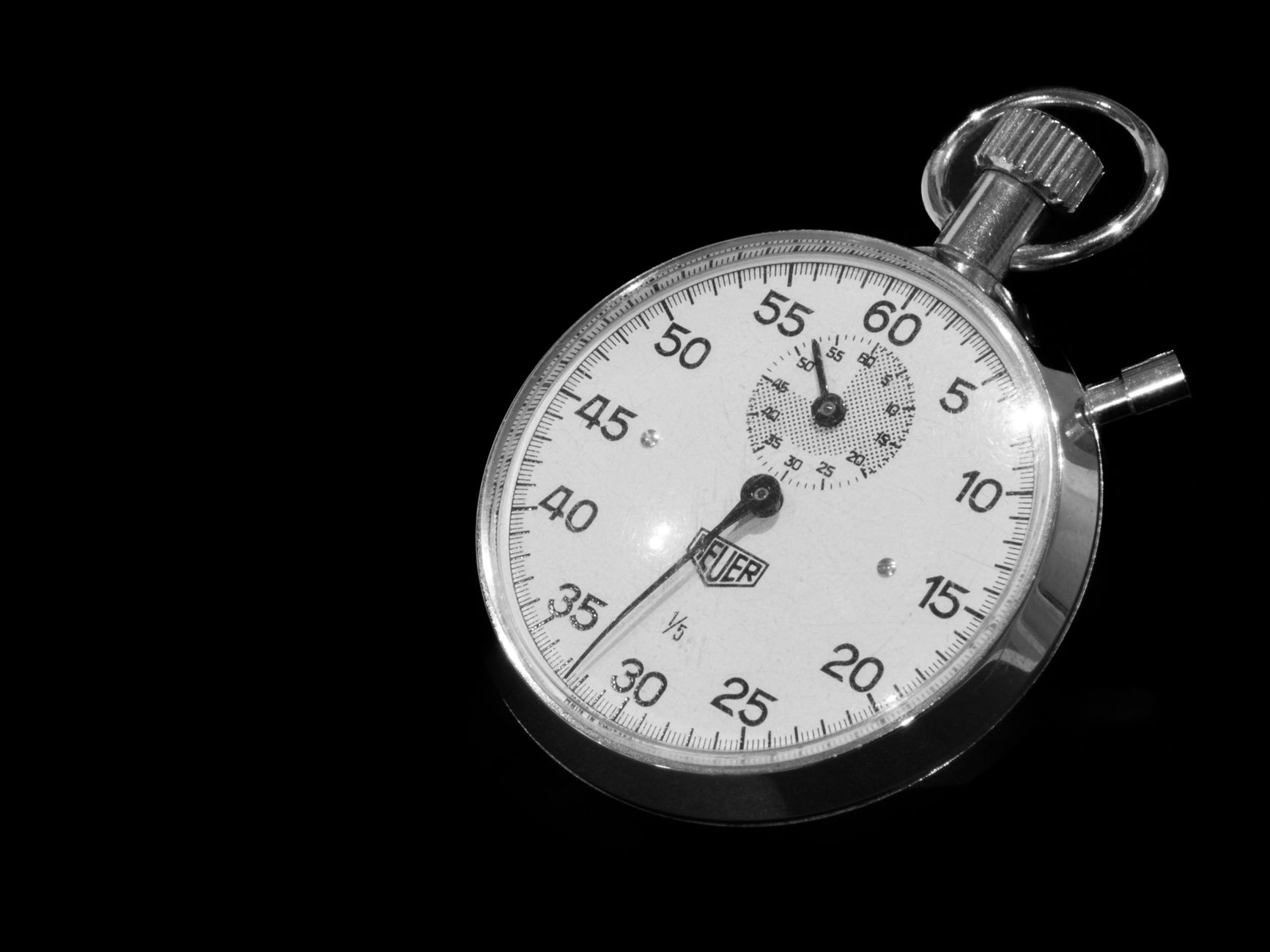Engineer timing a work cycle with a stopwatch