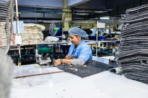 Operator working at an assembly station on the factory floor
