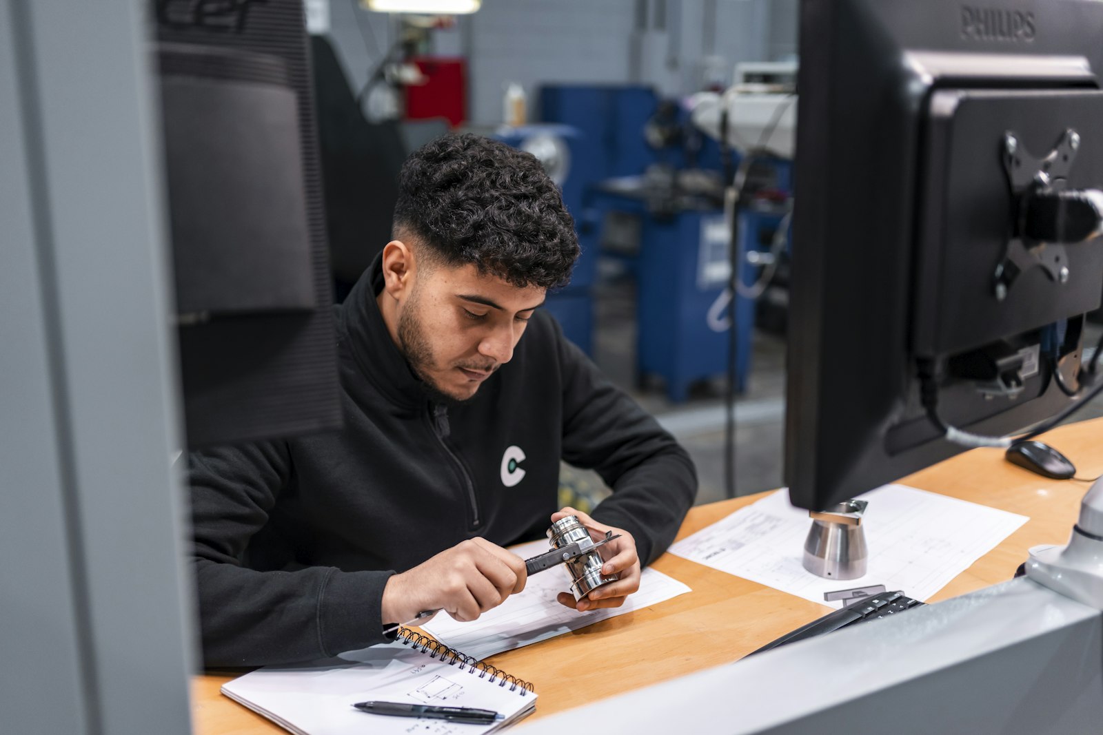 Technician taking a precision measurement at an industrial workstation