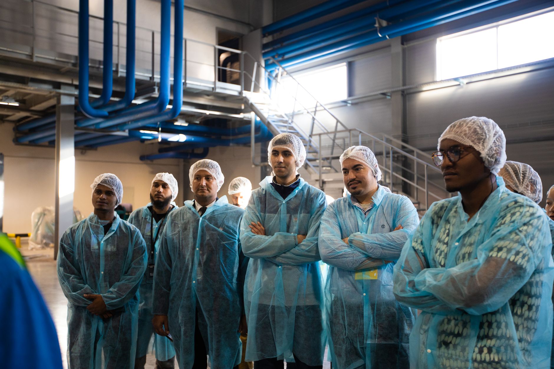Manufacturing team standing together during a shift briefing