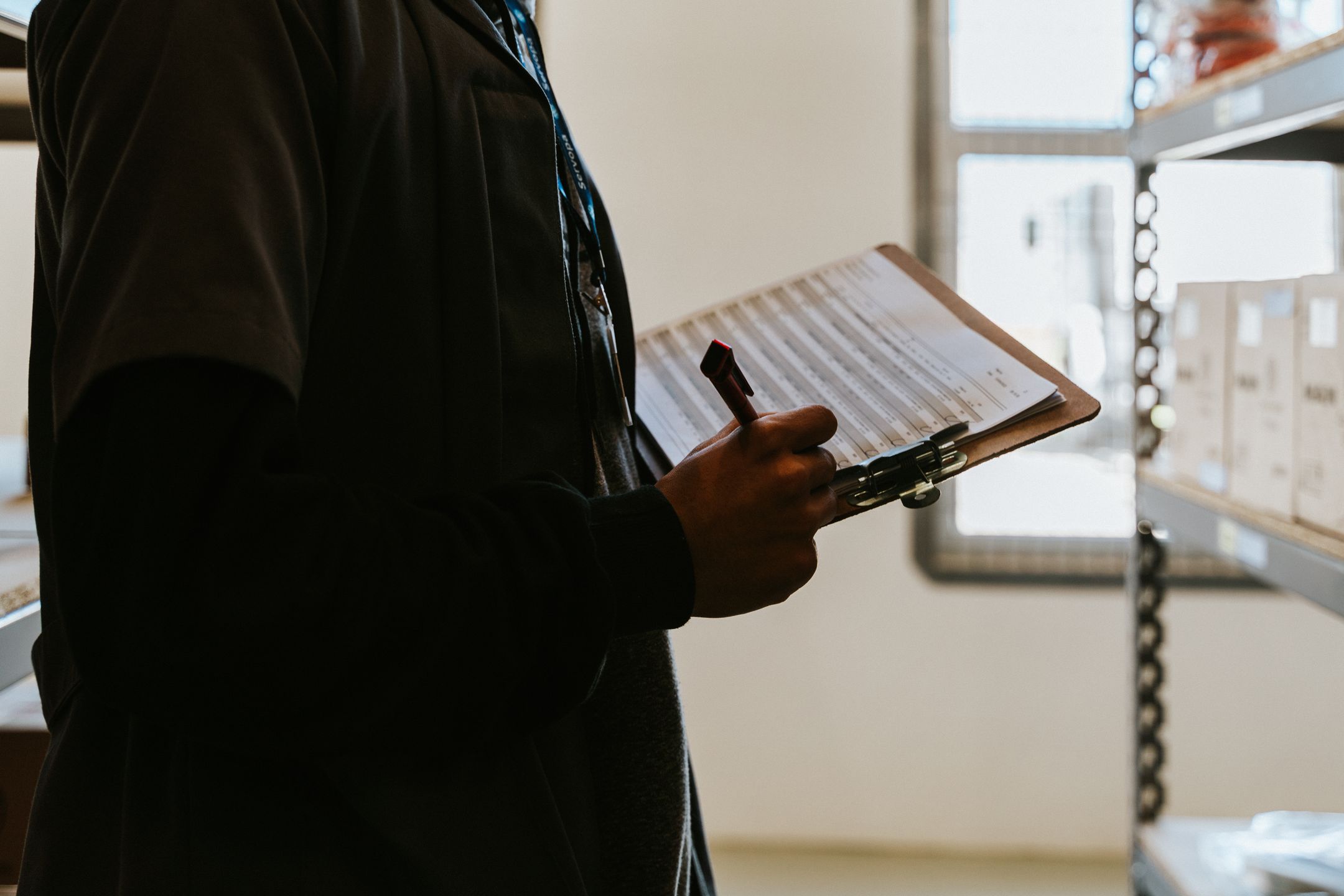 Auditor reviewing a checklist on a production line