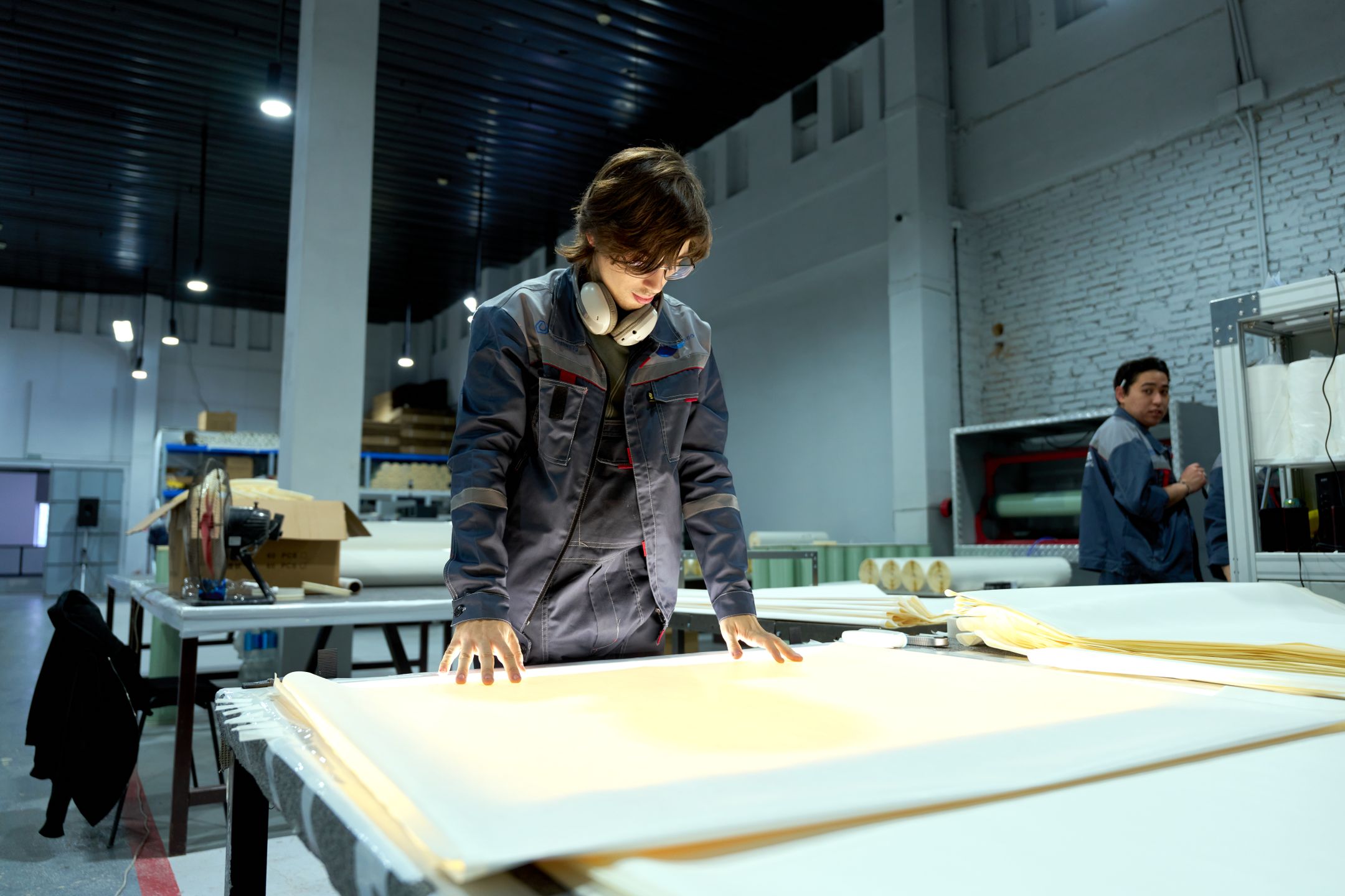 Worker examining production materials in a factory