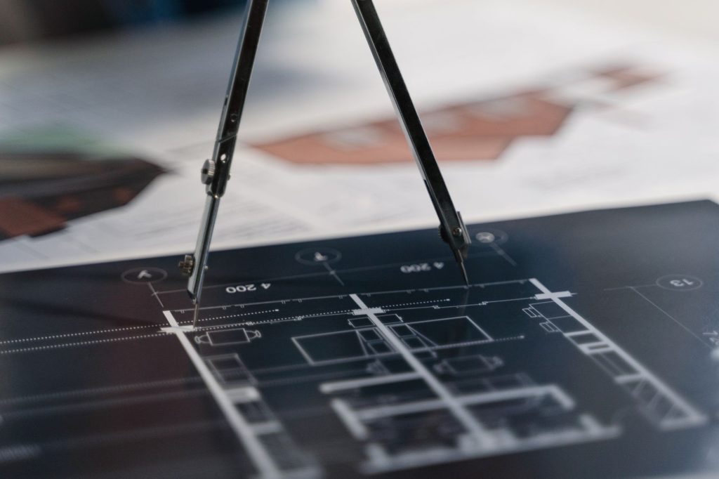 Divider tool used to measure dimensions on a technical drawing